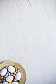 White eggs and sugar eggs in bowl