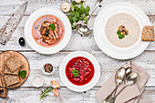 Three soup varieties: soljanka, mushroom cream soup, and beetroot soup