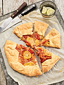 A sliced tomato galette on baking paper