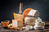 Various types of cheese on rustic wooden table