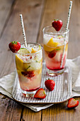 Champagne cocktails with strawberries and mango