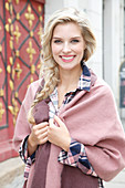 A young blonde woman wearing a shawl