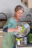 Woman using a pressure cooker