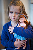 4 year old girl with her doll