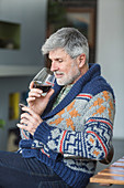 Man drinking a glass of red wine