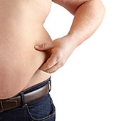 Topless overweight man holding body fat