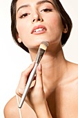Woman applying foundation with brush