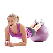 Woman doing plank on fitness ball