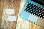Laptop and blank business cards on desk