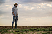 Male farmer standing on farmland