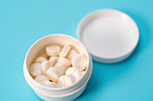 White tablets in plastic container