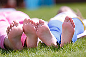 Girls' bare feet on grass