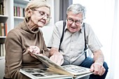 Senior couple looking at photo album