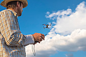 Farmer piloting drone