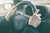 Driver's hands on steering wheel