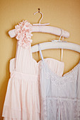 Vintage-style lady's clothing on clothes hangers