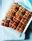 Hot cross buns with icing, chocolate, and raisins