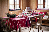 Christmas decorations on table with drawer in rustic cabin parlour