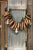 Garland of fir cones on rustic wooden shutter