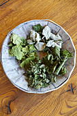 Bowl of dried leaves for making homemade herbal tea