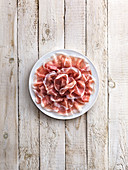 Italian raw ham on a white plate