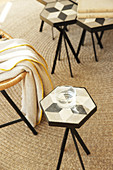 Glass of water on side table with top made from hexagonal cement tile