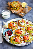 Courgette fritters with smoked salmon and cream and pomegranate