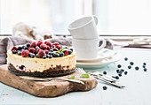 Cheesecake with fresh raspberries and blueberries