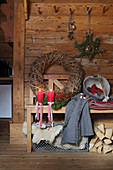 Christmas decorations and bench in rustic wooden cabin
