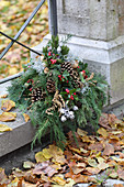 Grave arrangement of conifer twigs, Gaultheria berries, pine cones and silver ragweed