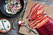 Beetroot and gin cured salmon with pickled radishes and cucumber