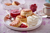 Scones with clotted cream and raspberry jam