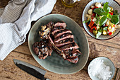 Bistecca: T-bone steak with olive oil and sea salt served with salad (Italy)