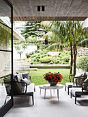 Designer outdoor furniture on a terrace with a concrete ceiling