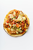 Mexican taco with chili con carne, grilled sweet potatoes and grated cheese on white background