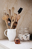 Various kitchen utensils in ceramic jug