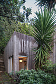 Modern wooden house in tropical garden