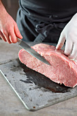 Topside of veal being cut