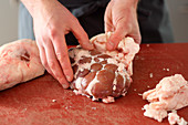 Veal kidney being trimmed (fat and skin being removed)