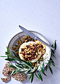 Baked camembert with rosemary, macadamia and cranberry crumble