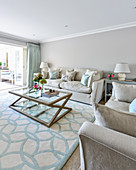 Elegant living room in shades of grey with pale blue accents