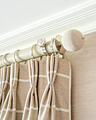 Beige checked curtain draped in elegant folds