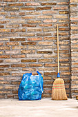 Household broom and bag of rubbish