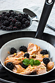 Pulled salmon with blackberries and pine nuts