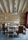 Brown upholstered chairs around table in dining room of chalet