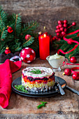 Russian Shuba salad with herring, potato, carrots, beetroot and sour cream