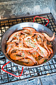 Prawns with garlic in a pan on a grill