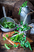 An arrangement of peas with pods and leaves