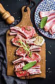 Raw uncooked lamb chops with herbs and spices