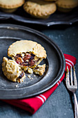 A mince pie on a metal plate with a red napkin
